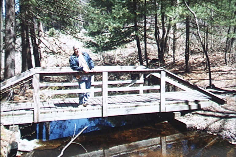 Susan is leaning against a tree to take this picture and hoping to not fall into the stream!  This same stream runs through our property about three quarters of a mile behind Susan.