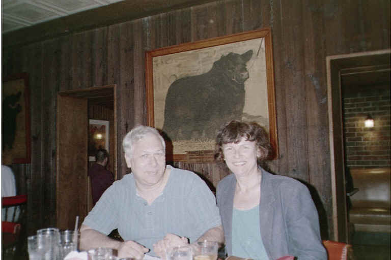 In this restaurant, at the end of the room to the right of Susan, there were steaks on ice in a glass showcase and the chef was right there in the room cooking them on an open grill.  The customers all get to observe their steaks being prepared.